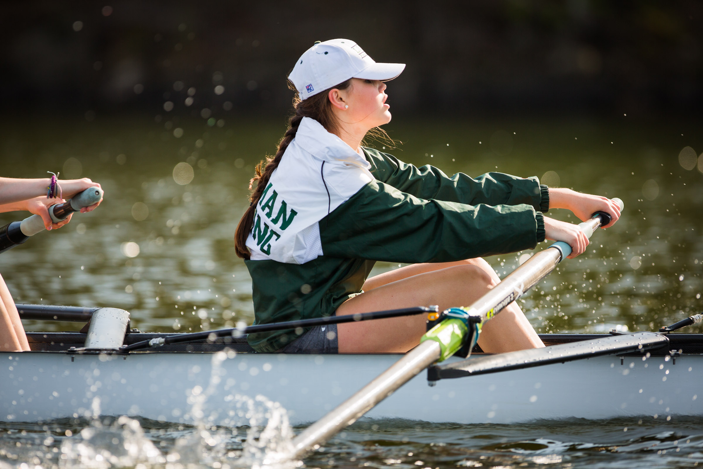 A Forman student rows in her crew boat on the river
